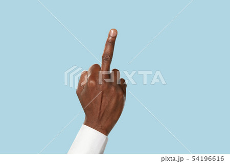 Male hand demonstrating a gesture of fuck isolated on blue background 54196616