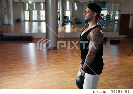 man in sportswear is training in the gym 54198491