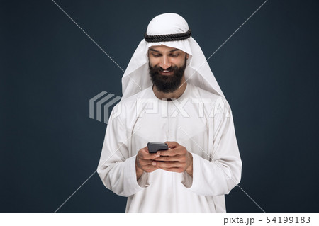Arabian saudi man on dark blue studio background 54199183