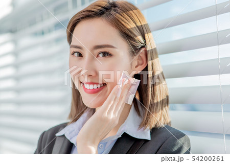 woman use oil blotting paper woman use oil blotting paper 54200261