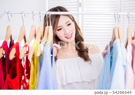 woman choosing clothes in showroom 54200344