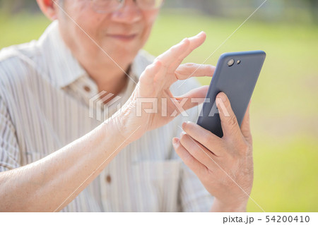 Older man use cellphone Older man use cellphone 54200410