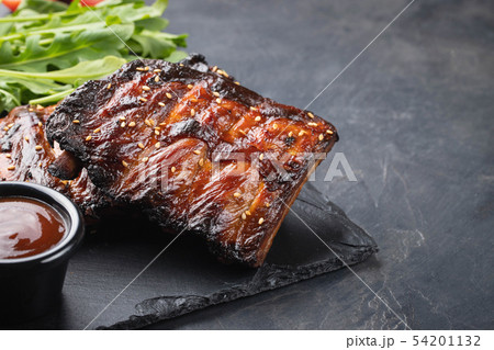 Closeup of pork ribs grilled with BBQ sauce. Closeup of pork ribs grilled with BBQ sauce. 54201132