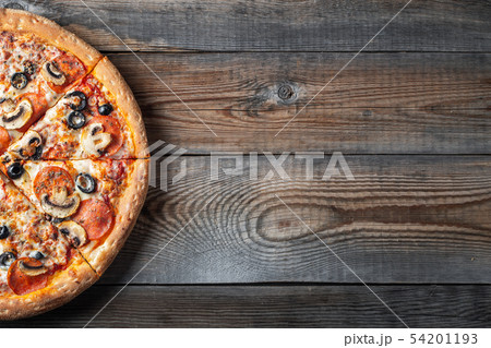 Tasty pepperoni pizza with mushrooms and olives. Tasty pepperoni pizza with mushrooms and olives. 54201193