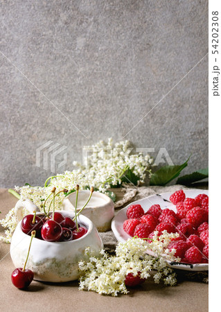 Fresh cherry and raspberry berries Fresh cherry and raspberry berries 54202308