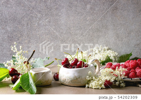 Fresh cherry and raspberry berries Fresh cherry and raspberry berries 54202309
