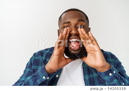 Young Afro-American man shouting. Shout. Emotional man screaming. Human emotions, facial expression 54203339