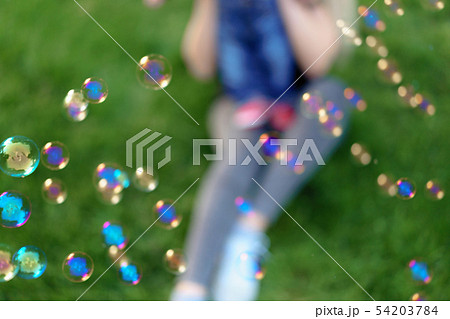 Unfocused unrecognizable mother inflates soap Unfocused unrecognizable mother inflates soap 54203784