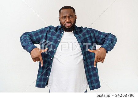 Young amazed African American pointing his finger at white background with copy space for your Young amazed African American pointing his finger at white background with copy space for your 54203796