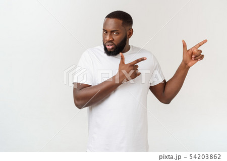 Young amazed African American pointing his finger at white background with copy space for your 54203862