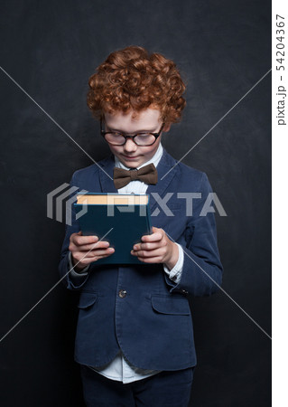 Child with book on chalkboard background Child with book on chalkboard background 54204367