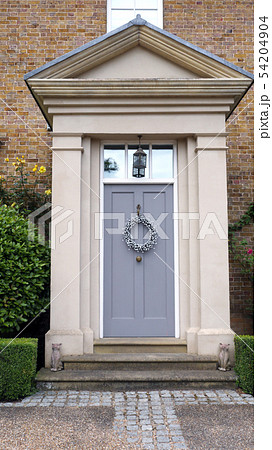 Elegant wooden grey doors with hanging wreath 54204904