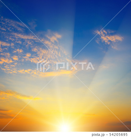 Scenic sunset with sun rays against bright blue Scenic sunset with sun rays against bright blue 54205695