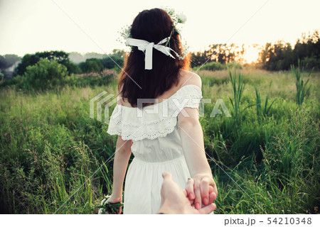 Follow me concept. Back of a girl holding her boyfriend's hand 54210348