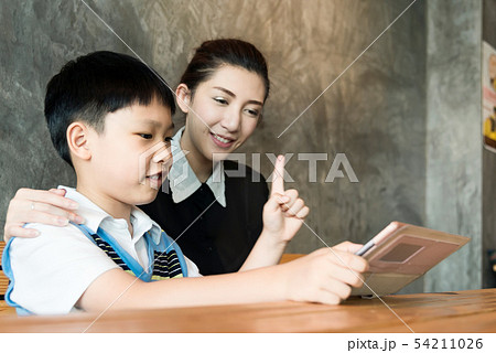 Asian,Woman and little boy sitting, playing tablet Asian,Woman and little boy sitting, playing tablet 54211026