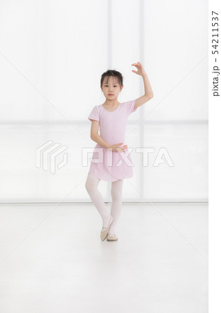 Pink dressed Asian girl in a ballet pose.. 54211537