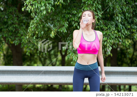Asian woman drinking water. 54213071