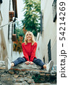 Smiling blonde girl with red shirt enjoying life 54214269