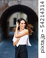 Young woman moving her long hair in urban 54214314