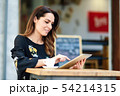 Middle-aged woman using tablet on coffee break in 54214315
