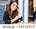 Middle-aged woman using tablet on coffee break in 54214317