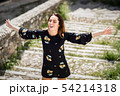 Middle-aged woman enjoying the sunlight in an old 54214318