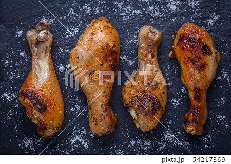 Roasted chicken legs on the black background. Top view. Roasted chicken legs on the black background. Top view. 54217369