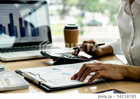 Business adviser analyzing financial figures Business adviser analyzing financial figures 54218785