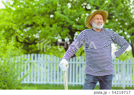 Grey-haired man smiling while enjoying time outside the city 54219717
