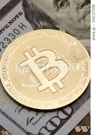 golden bitcoin coin on us dollars close up. 54222506