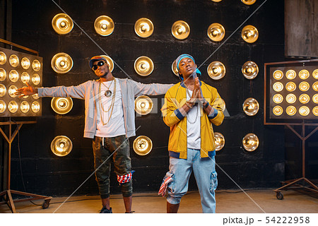 Two black rappers in caps, artists poses on stage 54222958