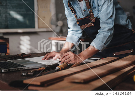 Carpenter working with equipment on wooden table 54224134