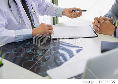 Patient listening intently to a male doctor 54224135