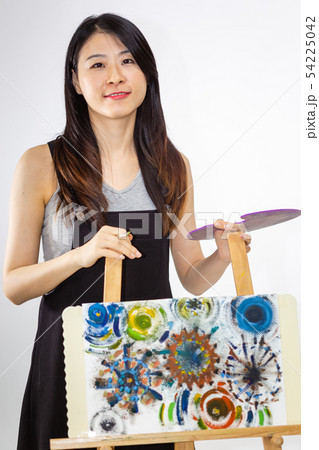 Artist holding painting palette and brush Artist holding painting palette and brush 54225042