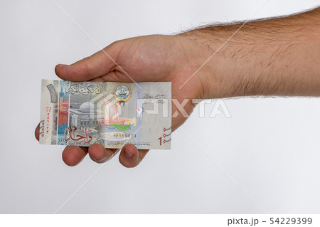 Kuwaiti dinar banknote in hand. 54229399