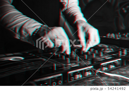 DJ in booth playing in nightclub on background of mixer DJ in booth playing in nightclub on background of mixer 54241492