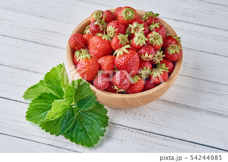 strawberries in wooden bowl on gray background 54244985