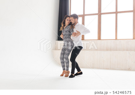 Social dance concept - Active happy adults dancing bachata together over white background with copy 54246575