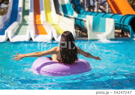 pretty woman on rubber ring in the pool 54247247