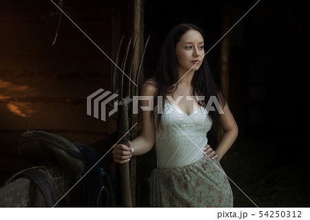 Young woman on a ranch. 54250312
