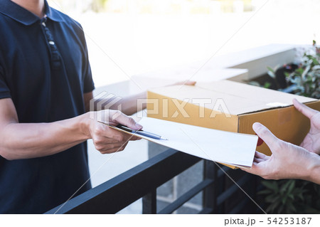 Delivery mail man giving parcel box to recipient Delivery mail man giving parcel box to recipient 54253187