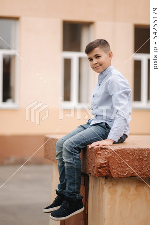 Cute boy in shirt stand on front of school Cute boy in shirt stand on front of school 54255179