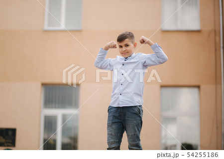 Cute boy in shirt stand on front of school 54255186