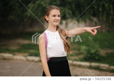 Young girl walking in the park with backpack Young girl walking in the park with backpack 54255198