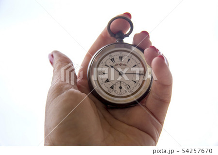 close up of hands with vintage pocket watch retro 54257670