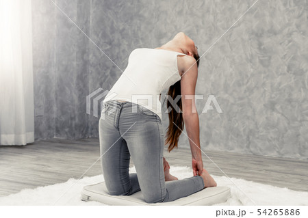 Young woman yoga on carpet at home living room. 54265886