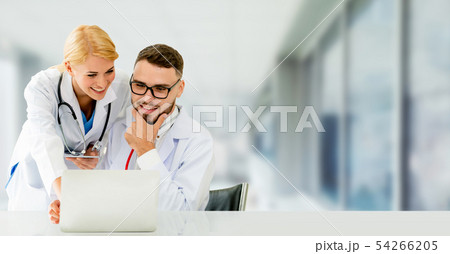 Doctors working with laptop computer in hospital. 54266205