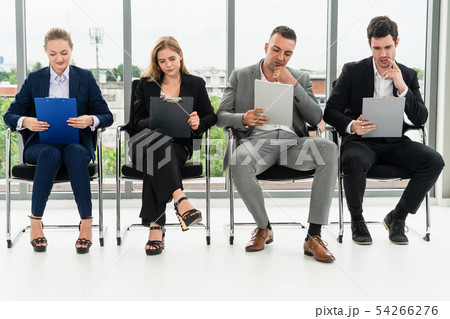 Businesswomen and businessmen wait for interview. Businesswomen and businessmen wait for interview. 54266276