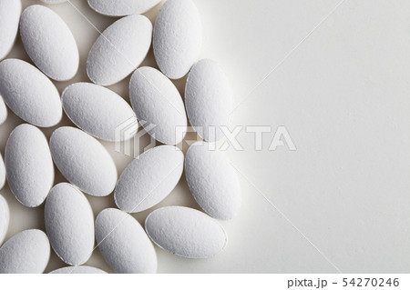 Pile of white drug pills laying on white Pile of white drug pills laying on white 54270246