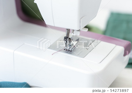 Close-up of a sewing machine foot with purple thread ready for work and sewing a new design product 54273897
